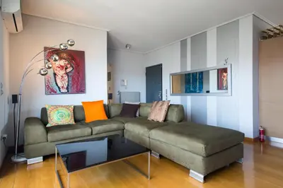 a living room with a couch and a table at Acropolis Tony's Penthouse in Athens