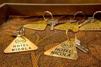 four pairs of keys sitting on top of a table at Nicola Hotel in Athens