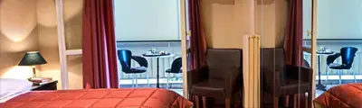 a bedroom with a balcony with a table and chairs at Nicola Hotel in Athens