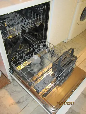 an open dishwasher with dishes inside of it at Kavouri Flat in Athens