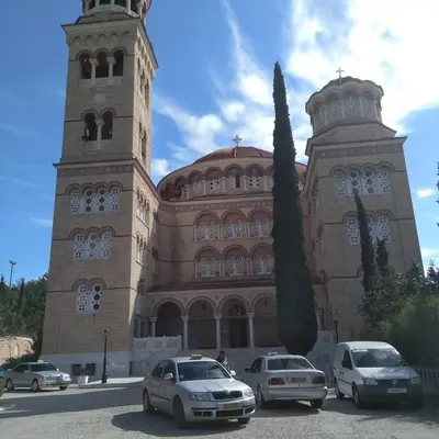 a large building with cars parked in front of it at Svetlana & Michalis Oasis Hotel in Agia Marina Aegina