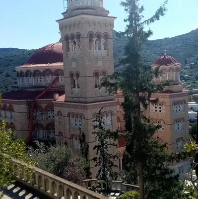a large building with a tower on top of it at Svetlana & Michalis Oasis Hotel in Agia Marina Aegina
