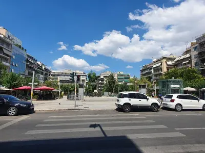 three cars parked in a parking lot in a city at Pedion Areos Park 4 Center 4 in Athens
