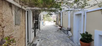 an alley with a stone walkway between two buildings at Villa Emily in Lagonissi