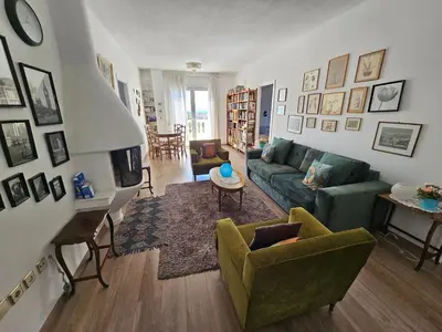 a living room with a green couch and chairs at Villa Emily in Lagonissi