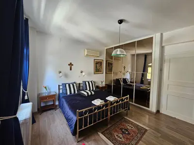 a bedroom with a bed and a mirror at Villa Emily in Lagonissi