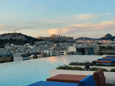 a rooftop pool with a view of a city at Grand Hyatt Athens in Athens