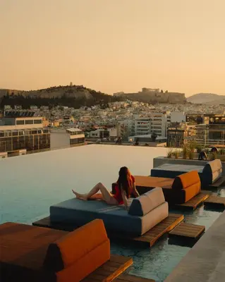 a woman laying on a couch on a rooftop at Grand Hyatt Athens in Athens