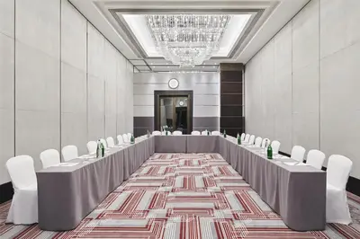 a conference room with tables and chairs and a chandelier at Grand Hyatt Athens in Athens