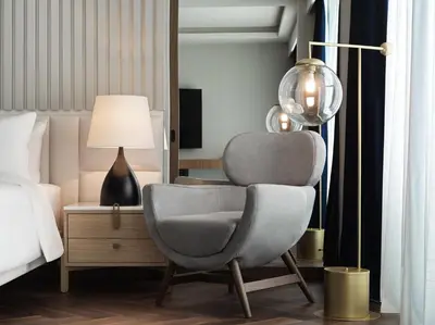 a bedroom with a chair next to a bed at Grand Hyatt Athens in Athens