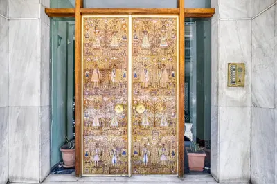 a gold door with a lot of items on it at Studio in The Heart of Acropolis in Athens