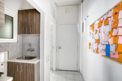 a bathroom with a sink and a wall with notes at Studio in The Heart of Acropolis in Athens