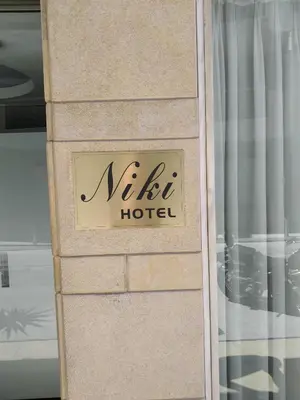 a sign for a hotel on the side of a building at Hotel Niki Piraeus in Piraeus
