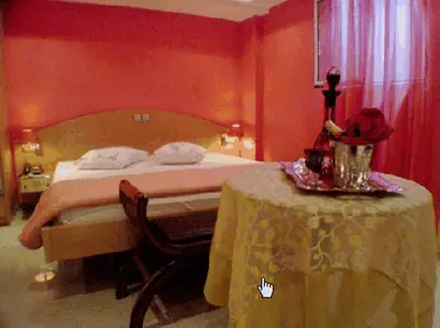a hotel room with a bed and a table with a table sidx sidx at Hotel Niki Piraeus in Piraeus