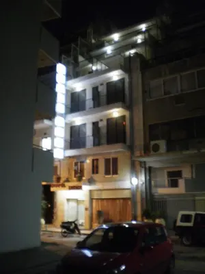 a building with a car parked in front of it at night at Hotel Niki Piraeus in Piraeus