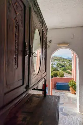 a hallway with an archway leading to a room with a view at Vagia Traditional, Aegina Island in Vaia