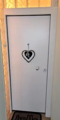 a white door with a heart shaped sign on it at Driopon Apartment in Athens