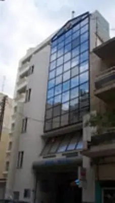 a tall building with a lot of windows on it at Driopon Apartment in Athens
