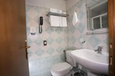 a bathroom with a toilet and a sink at Hotel Katerina in Athens