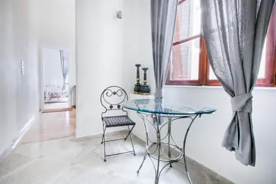 a glass table and a chair in a room at Central Apartments in Psiri - Athens in Athens