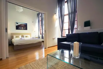 a living room with a couch and a bed at Central Apartments in Psiri - Athens in Athens