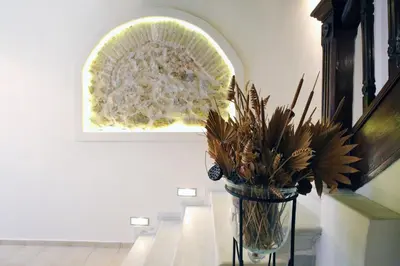 a vase with flowers on a table in a room at Central Apartments in Psiri - Athens in Athens