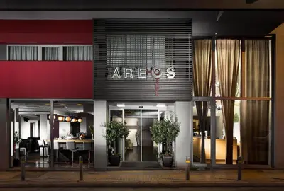 a store front with a sign that reads arios at Areos in Athens