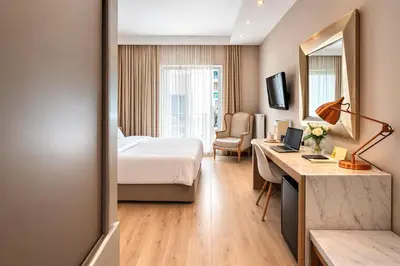 a hotel room with a bed and a desk at Areos in Athens