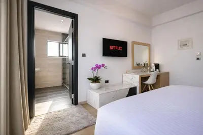 a bedroom with a bed and a walk in shower at Areos in Athens