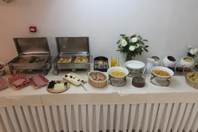 a table with a buffet of food on it at Achillion Hotel in Athens