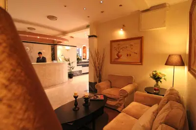 a living room with a couch and a table at Achillion Hotel in Athens