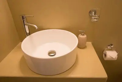 a bathroom with a white sink on a counter at Pefkides Aegina Boutique Apartments in Agia Marina Aegina