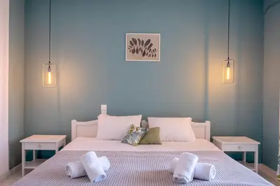 a bedroom with two beds with towels on them at Pefkides Aegina Boutique Apartments in Agia Marina Aegina