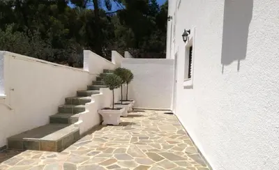 a staircase with potted plants on the side of a building at Pefkides Aegina Boutique Apartments in Agia Marina Aegina