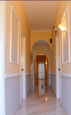 an empty hallway with an archway in a house at Hermes in Agia Marina Aegina