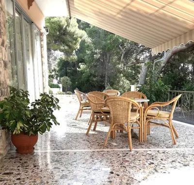 a group of chairs and a table on a patio at Hermes in Agia Marina Aegina
