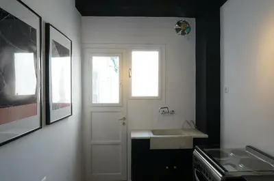 a kitchen with a white sink and a window at The Belgian Connection in Koukaki in Athens