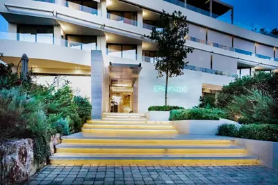 a building with yellow stairs in front of it at Somewhere Vouliagmeni in Athens