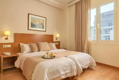 a bedroom with a large bed with a tray on it at Athos Hotel in Athens