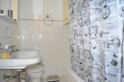 a bathroom with a sink and a toilet and a shower curtain at Pedion Areos Park 5 Center 5 in Athens