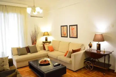 a living room with a couch and a table at Pedion Areos Park 5 Center 5 in Athens