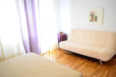 a living room with a couch and a bed at Pedion Areos Park 5 Center 5 in Athens