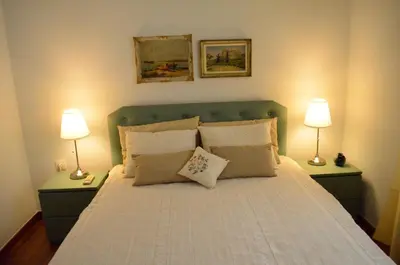 a bedroom with a large bed with two lamps at Pedion Areos Park 5 Center 5 in Athens