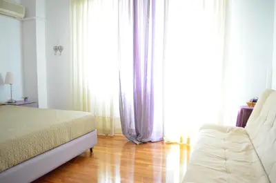 a bedroom with a bed and a large window at Pedion Areos Park 5 Center 5 in Athens
