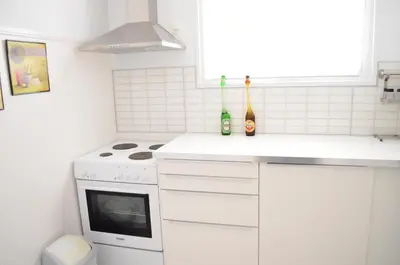 a white kitchen with a stove and a sink at Pedion Areos Park 5 Center 5 in Athens