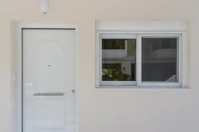 two white doors with windows on a white wall at Casa D'Irene Apartments in Athens in Athens