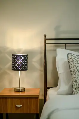 a lamp on a night stand next to a bed at Casa D'Irene Apartments in Athens in Athens