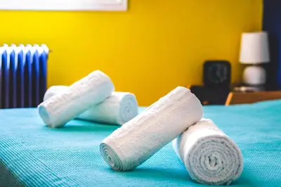 three rolls of toilet paper on a bed at Travel Resort in Athens