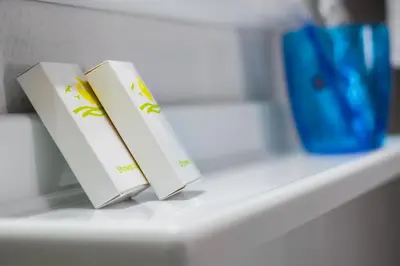 two books are sitting on a white shelf at Travel Resort in Athens