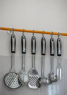 a group of utensils hanging on a wall at Travel Resort in Athens